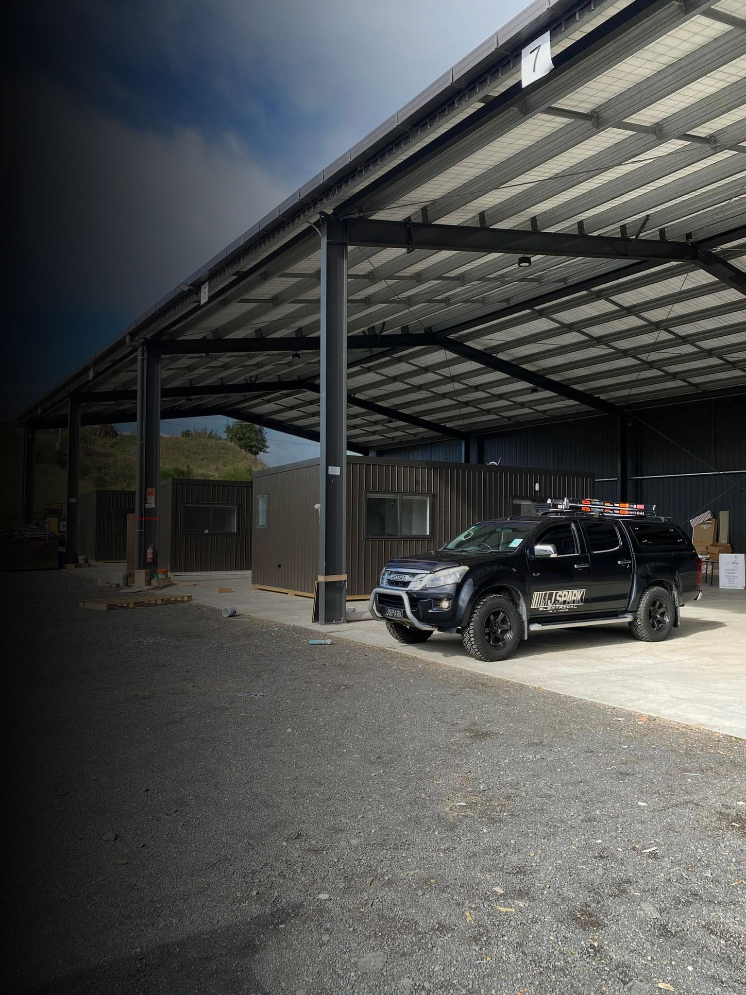 The J Spark Electrical ute parked on site under a steel canopy